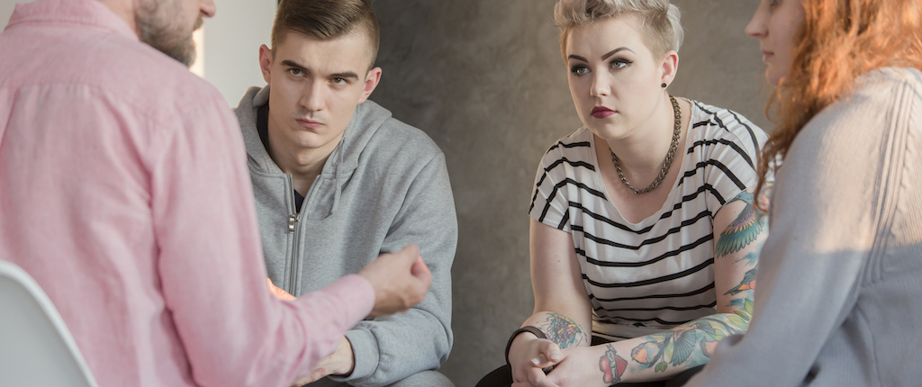 Denver Counseling Solutions psychologist talking with teenagers P3E8LLA